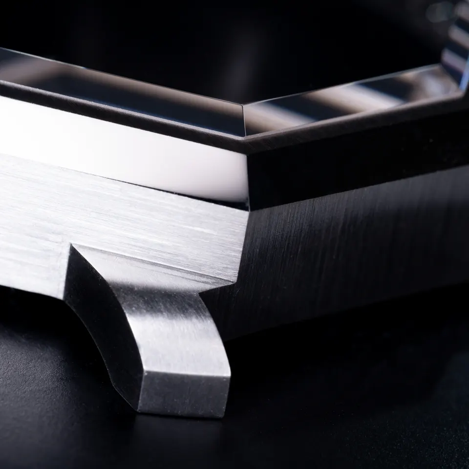 A steel case edge being finished by hand
