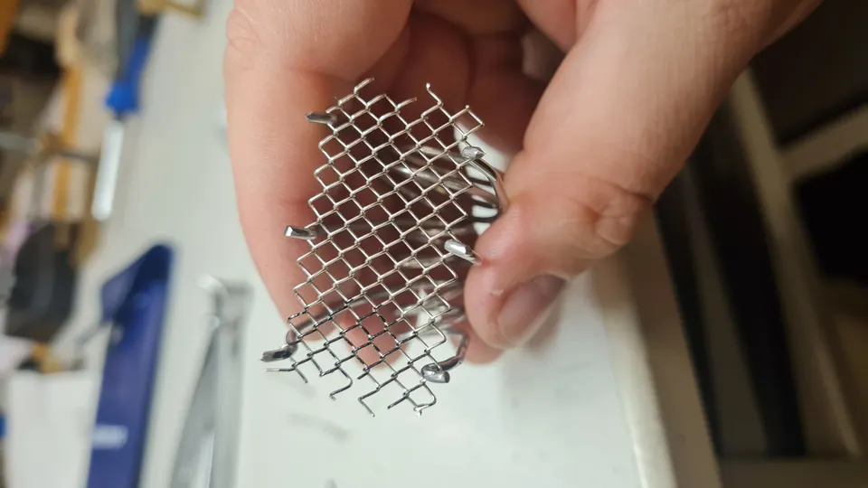 Hand-woven sterling-silver mesh held in the maker’s hand