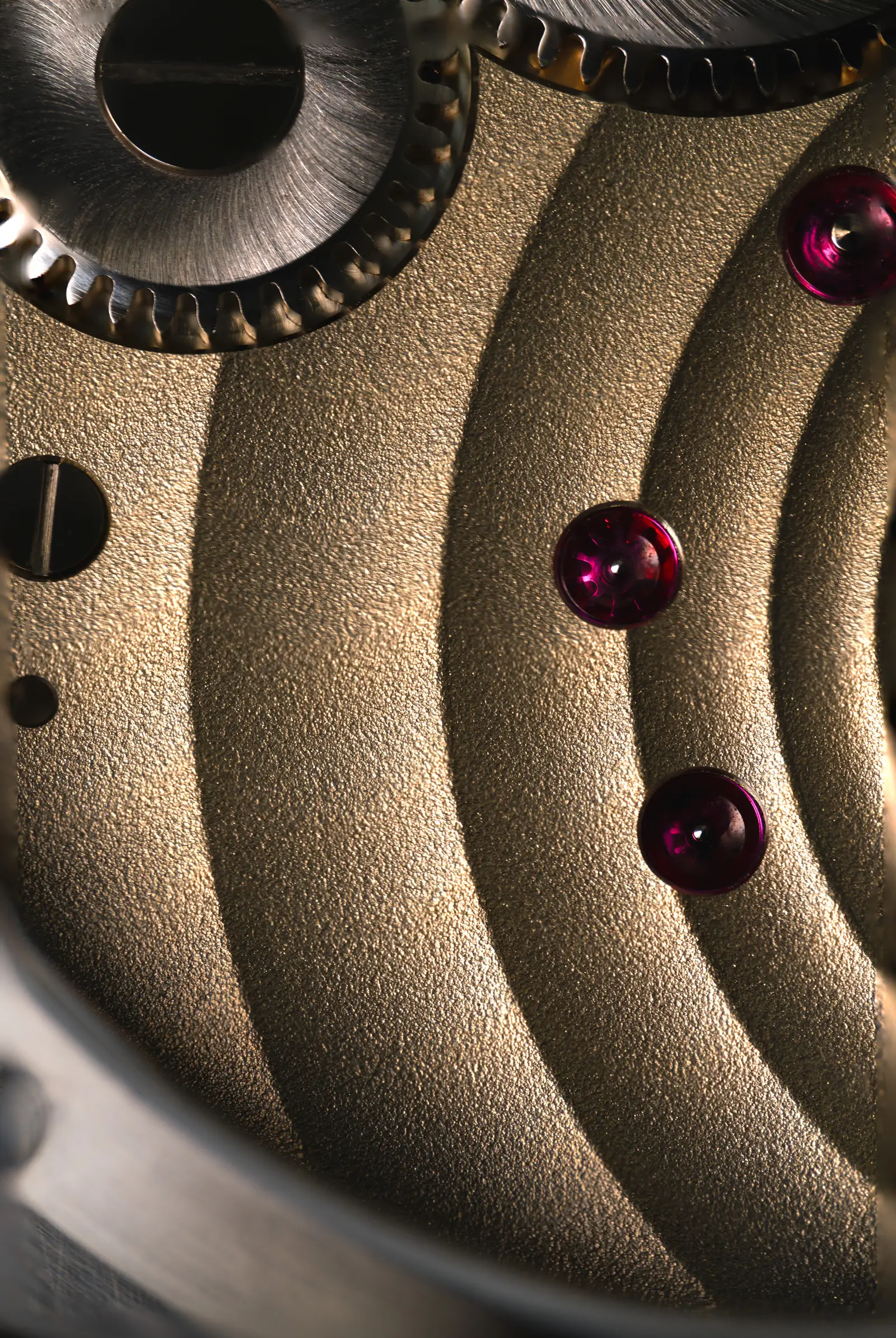 The in-house Rippling finish — golden wave-form decoration and ruby jewels on the movement of The Octagon